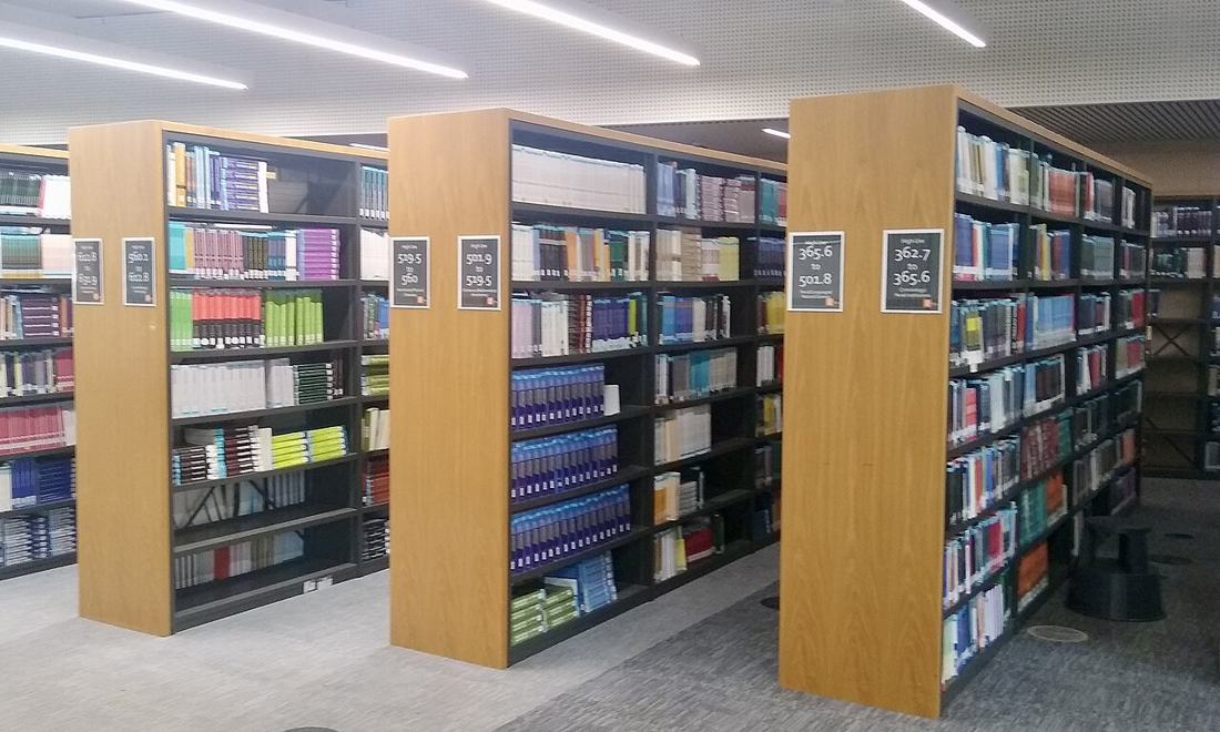 Books on library shelves. Appeals turn on the record — evidence and procedure, not new claims. Photo: Wikimedia Commons, CC0.