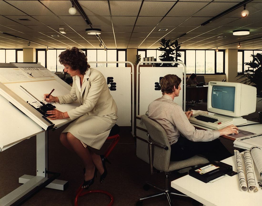 Office workers at their desks. Covered work in any occupation can earn SSDI credits. Photo: Wikimedia Commons, public domain.