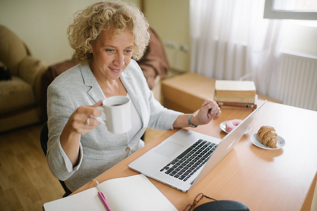 A woman working on a laptop at her office table. The Trial Work Period lets you test work without losing benefits. Photo: Wikimedia Commons, CC BY 2.0.
